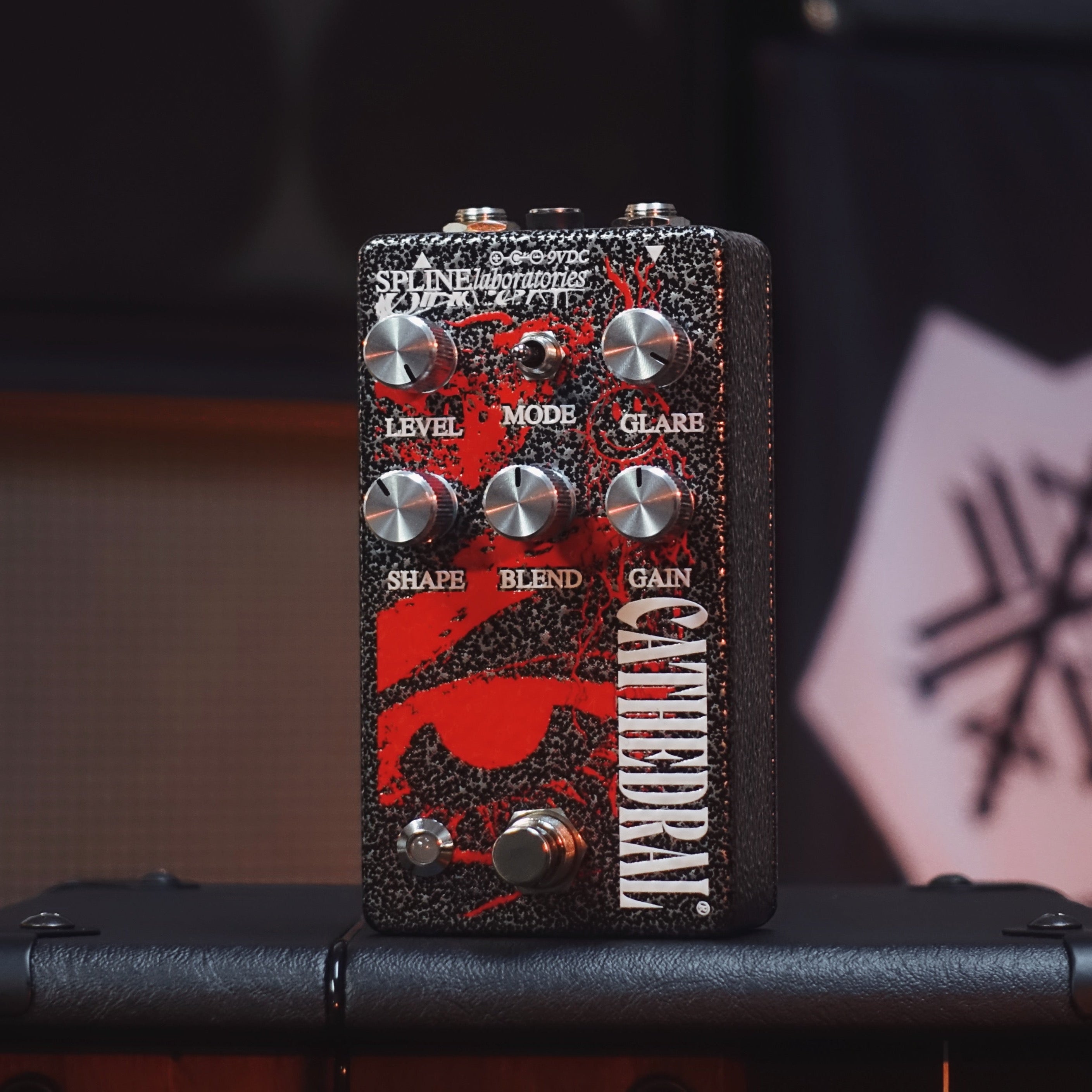 Cathedral fuzz and boost pedal Black and silver hammered enclosure with red art at Cult FX headquarters