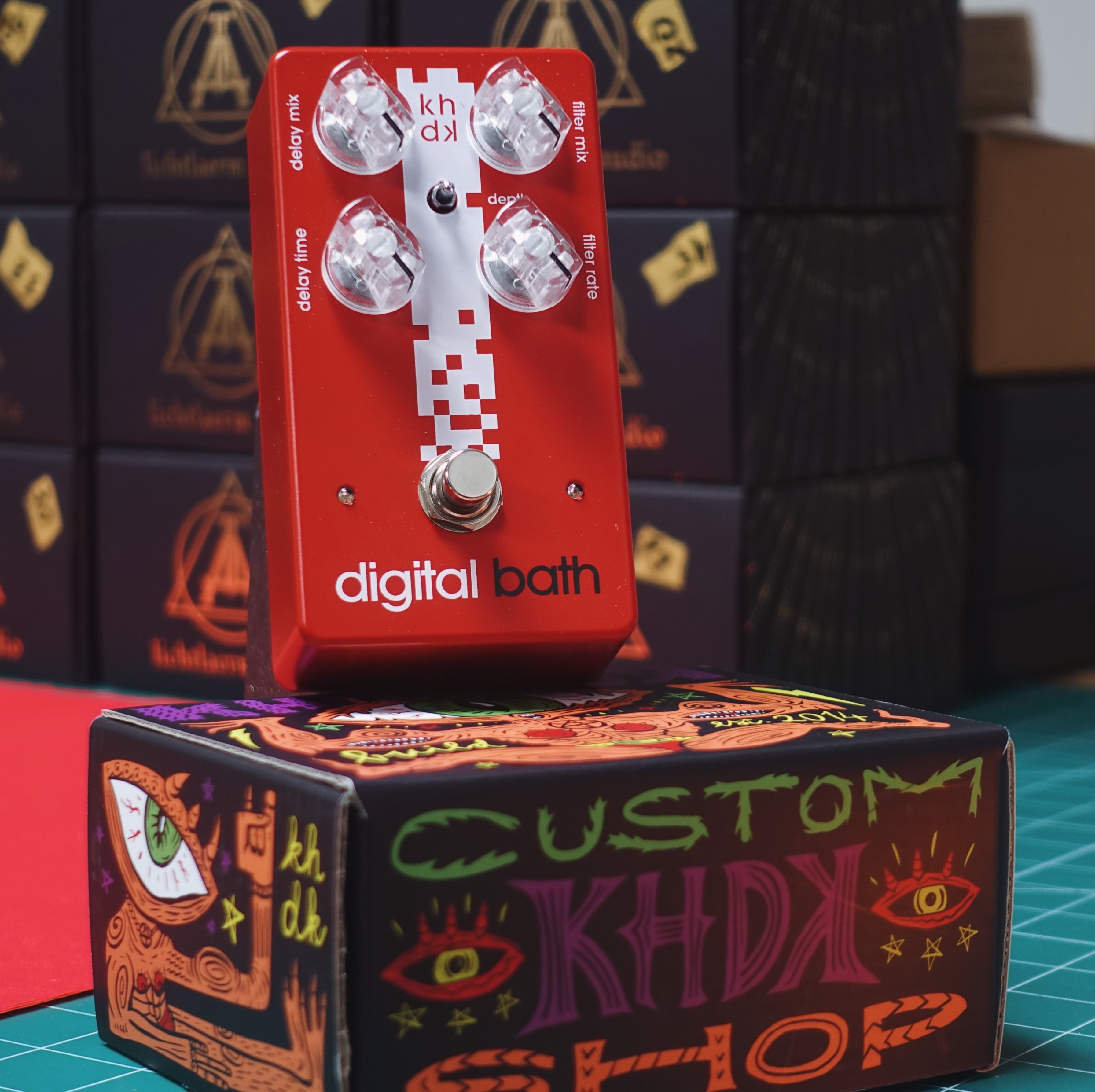 Red digital bath guitar effects pedal on a colorful box with 'Custom KHDX Shop' design.